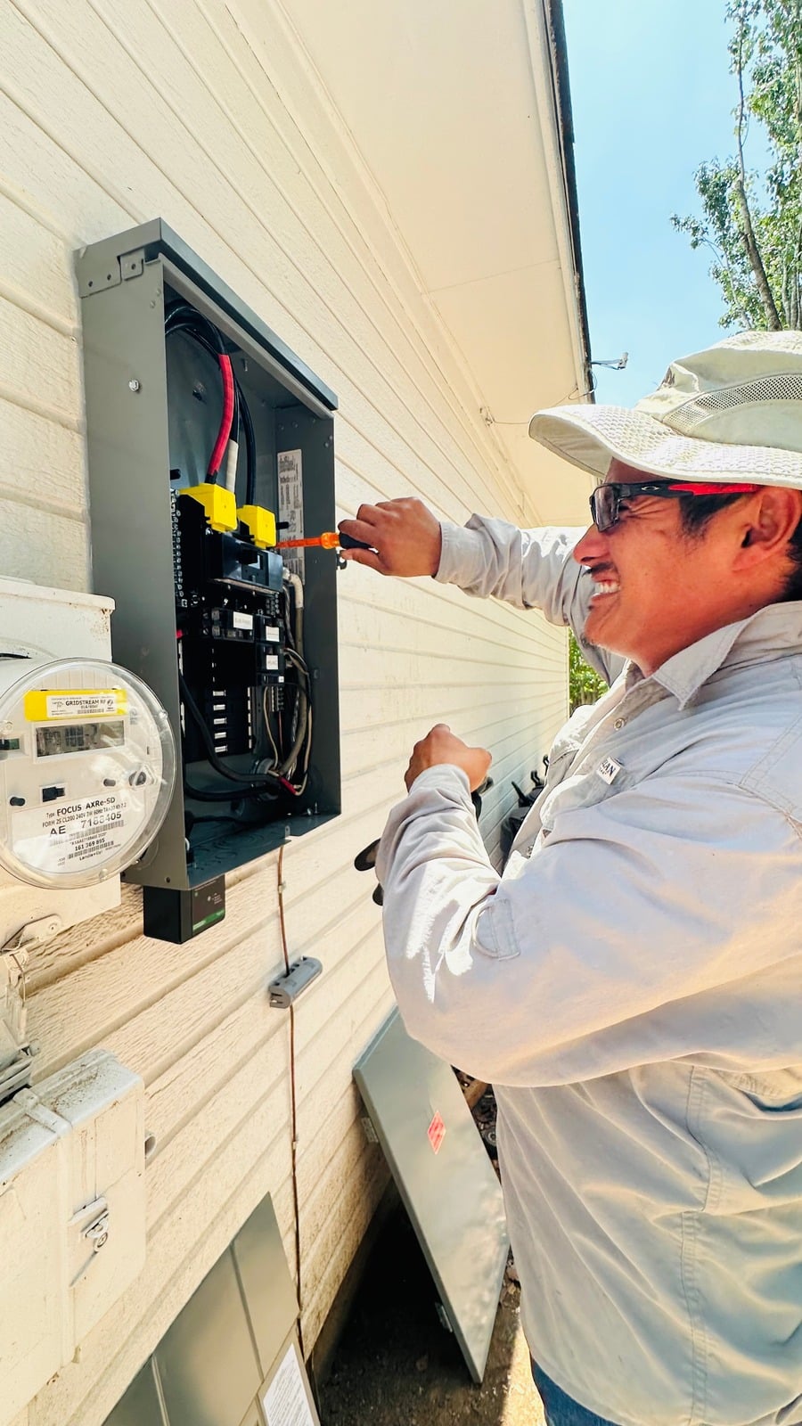 Electrician working on outdoor electrical panel — photo provided by business owner